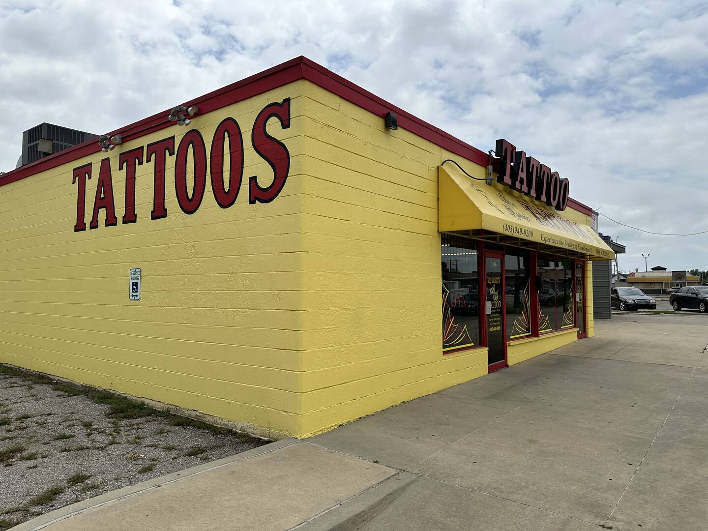 Side exterior view of Big Daddy's Tattoos OKC, showing the building and parking area